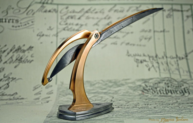 The Trebuchet -  A Damasteel "scalpel" in an adjustable Bronze/Damasteel stand.