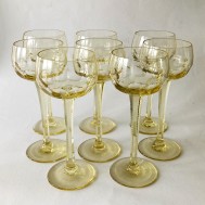 Eight yellow white wine glasses