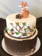 Höstig våningstårta med modellerad räv. Bark av chokladsockerpasta klär bottenvåningen, vit fondant på ovanvåningen. Höstig våningstårta med modellerad räv. Bark av chokladsockerpasta klär bottenvåningen, vit fondant på ovanvåningen.