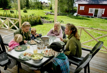 Family having dinner at the terrace.