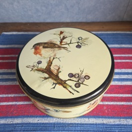Rund burk med fågelmotiv, IRA. Diam.  19,5 cm, höjd ca 8 cm. Liten buckla på locket, annars fint skick. 45 SEK