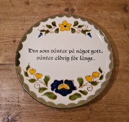 Väggtallrik Schramberg -  "Den som väntar på nåt gott, väntar aldrig för länge". Diam. 20 cm. Fint skick. 30 SEK