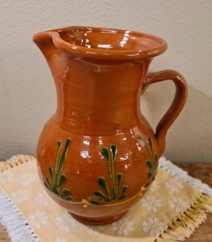 Ljusbrun keramikkanna med grönt motiv. Höjd 19,5 cm. Omärkt. Fint skick. 65 SEK