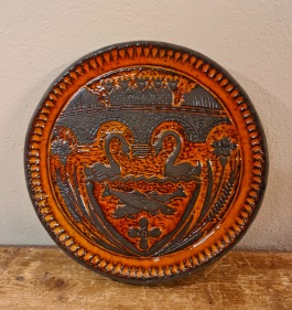 Rund keramiktavla från Norrmans, Motala. Motiv med svanar och fiskar. Nagg på baksidan av kanten, annars fint skick. 75 SEK