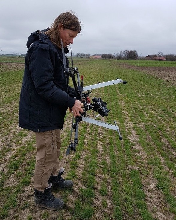 Fig. 3. Calibration of the Downwelling Light sensor at Lönnstorp. Per-Ola had to rotate the UAV in different ways according to the Micasense application (connected via WIFi to the cellphone). Photo by Ximena Tagle.