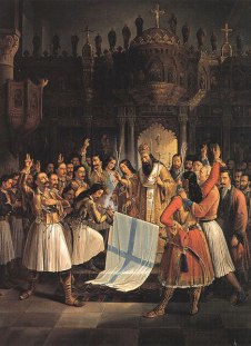 Source (Βικιπαίδεια/Wikipedia): Δοξολογία στην Αγία Λαύρα, Ο Παλαιών Πατρών Γερμανός ευλογεί την σημαία της επανάστασης. Source (Βικιπαίδεια/Wikipedia): Δοξολογία στην Αγία Λαύρα, Ο Παλαιών Πατρών Γερμανός ευλογεί την σημαία της επανάστασης.