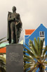 A statue and colorful houses at Willemstad, Curacao