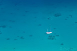 A lonely sailboat in the lagoon of Bora Bora, Tahiti
