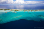 Bora Bora lagoon with overwater bungalow resorts side by side, Tahiti