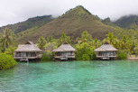 Overwater bungalows against the mountainous terrain at Moorea