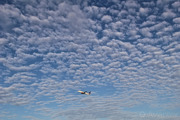 Beautiful cloud formations at Stockholm/Arlanda just as a Boeing 737-700 climbs away after departure.