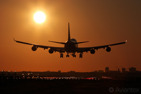 A Boeing 747-400 about to land during sunrise