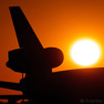 An old trijet DC10 parked during the setting sun