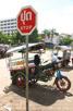 Tuk tuk parked by stop sign, Vientiane