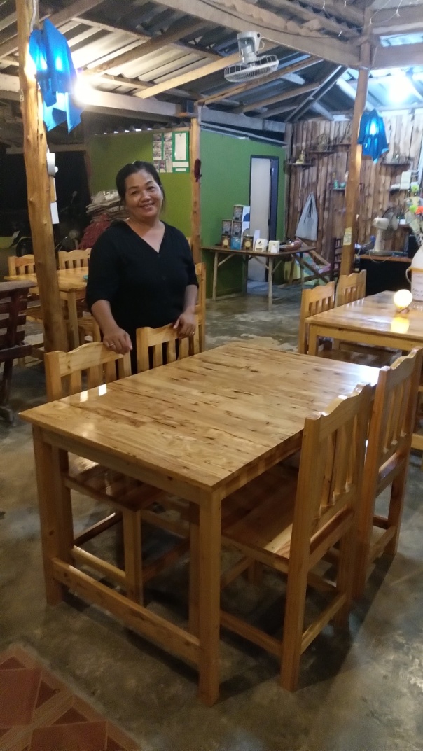 Kaew with dining table and chairs made by her husband
